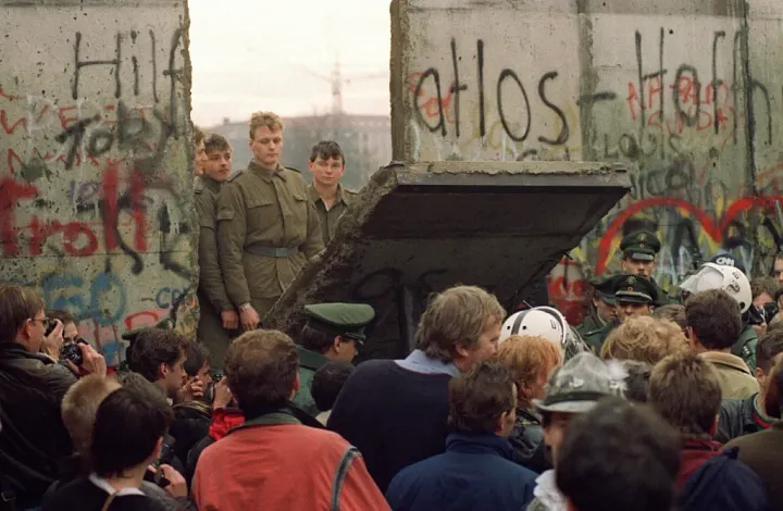 West Berliners crowd in front of the Berlin Wall early 11 November 1989 as they watch East German border guards demolishing a section of the wall in order to open a new crossing point between East and West Berlin ©Getty Images